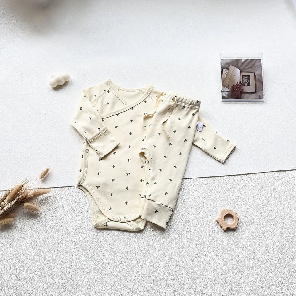 Cactus Printed White long sleeve baby bodysuit and pants set in an aesthetic light gray background