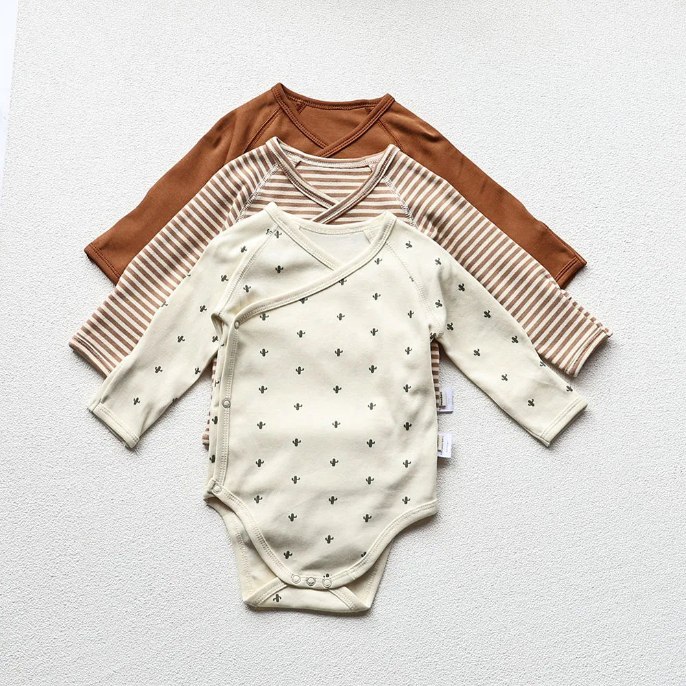 Baby Long sleeve bodysuit in three different designs and colors in a light gray background