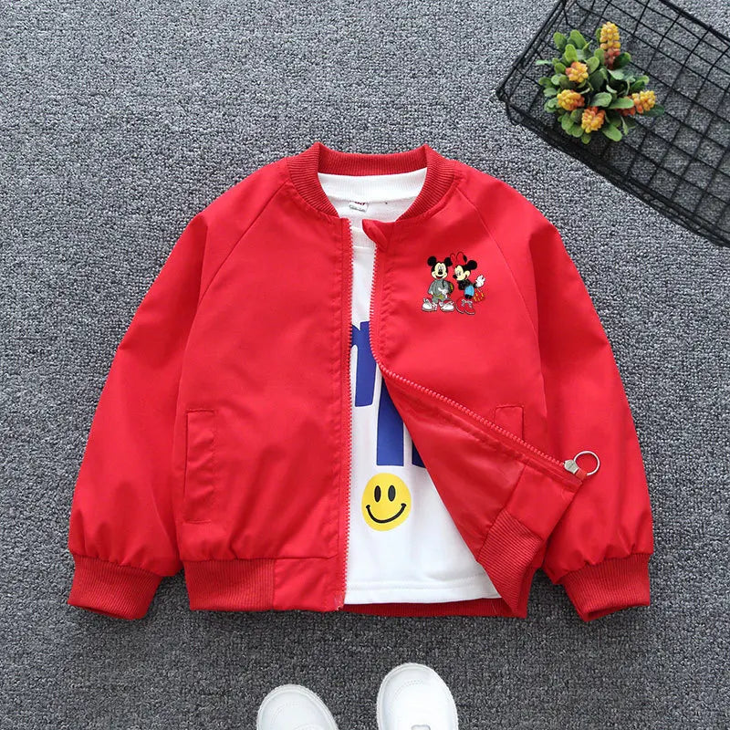 Red Mickey Mouse Design Printed Toddler Bomber Jacket Laid In a Gray Background With Basket Prop and White Shoes