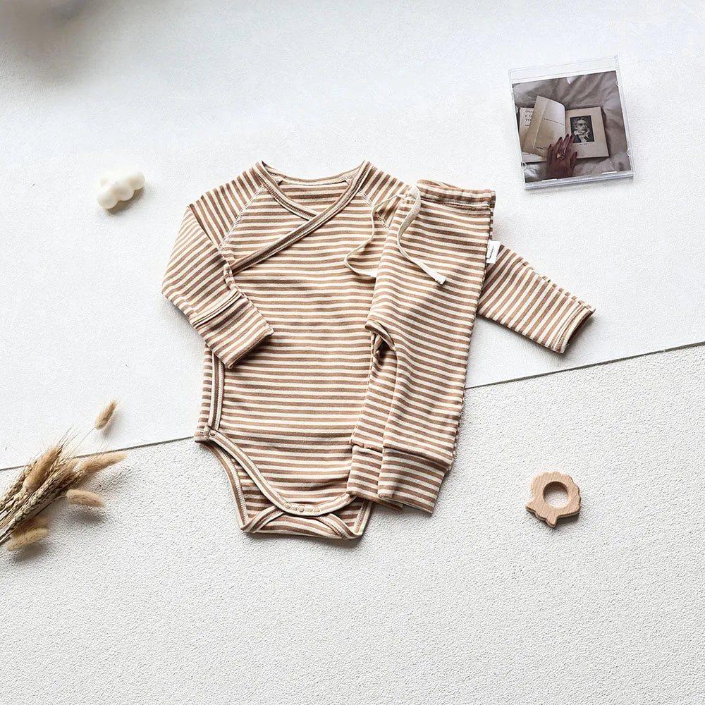 Brown and white striped long sleeve bodysuit and pants set in an aesthetic light gray background