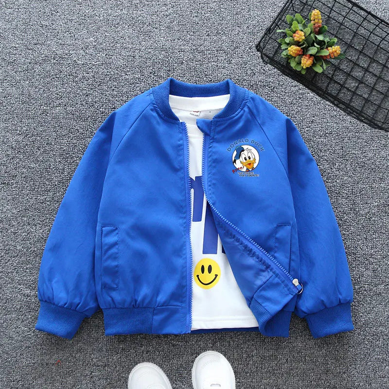 Blue Mickey Mouse Design Printed Toddler Bomber Jacket Laid In a Gray Background With Basket Prop and White Shoes