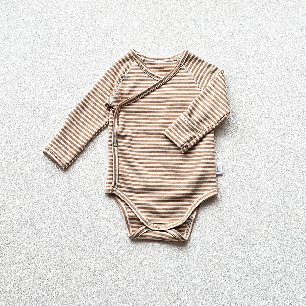 Brown and white striped baby long sleeve bodysuit in a light gray background