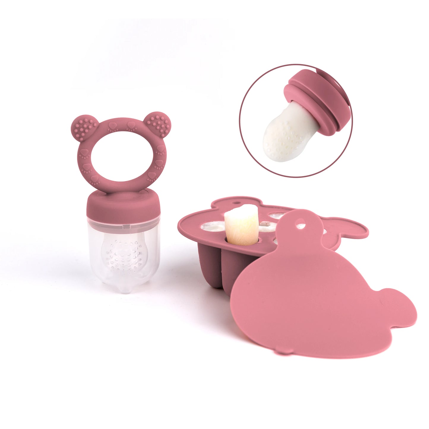 A pink baby fruit feeder with a silicone nipple and pacifier shaped like a bear.