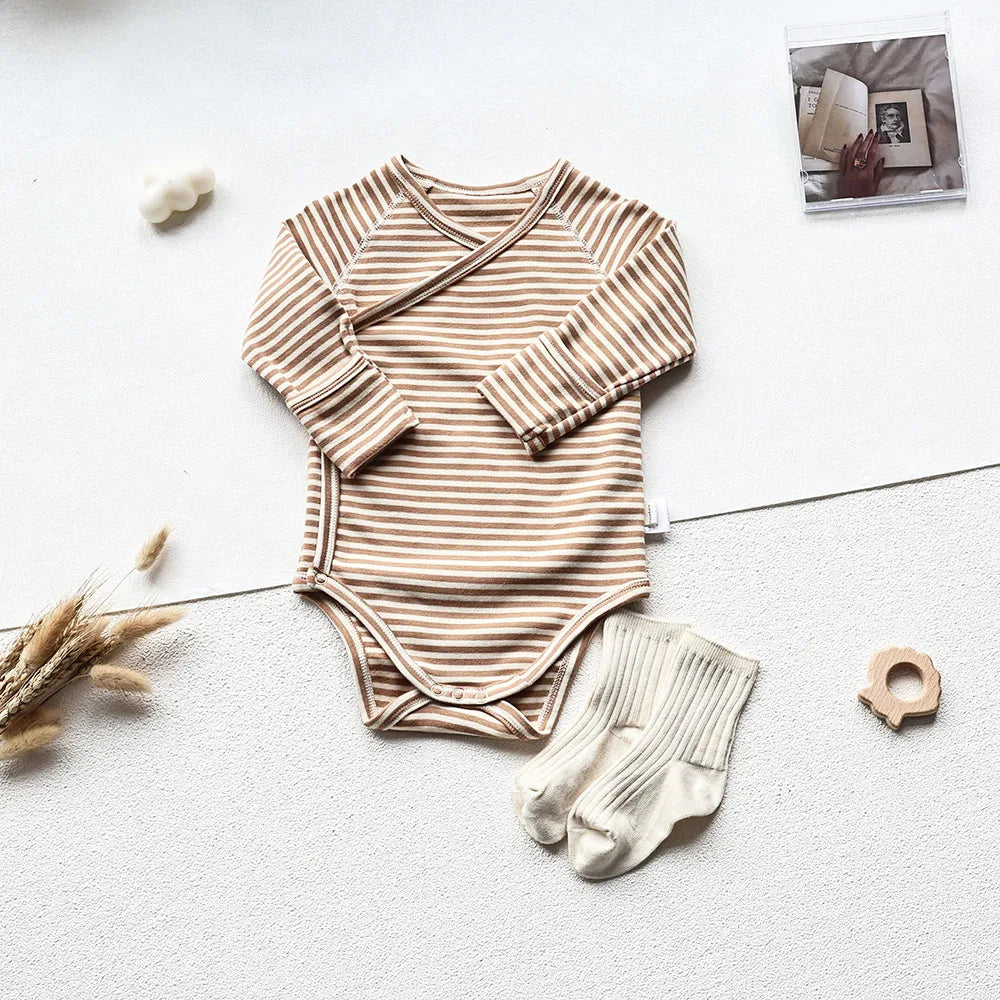 Brown and white striped long sleeve bodysuit with white socks in an aesthetic light gray background