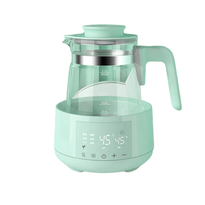Mint green electric tea kettle with transparent carafe and digital temperature display.