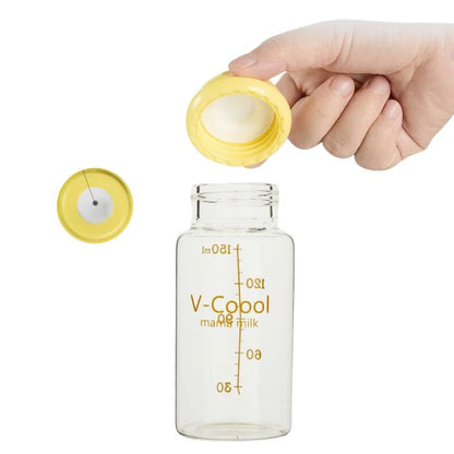 Clear glass baby bottle with measurement markings and V-Coool mama milk text.