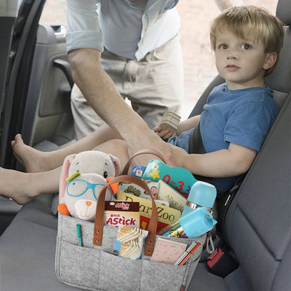 Gray Baby Felt Organizer Bag Filled With Baby Items In A Car With A Kid Traveling