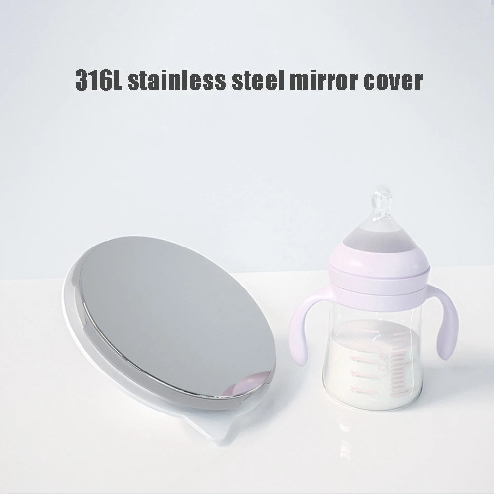 Silver stainless steel mirror next to a baby bottle with purple accents on a white surface.