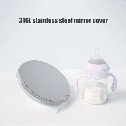 Silver stainless steel mirror next to a baby bottle with purple accents on a white surface.