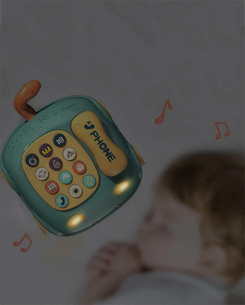 A toy phone in focus with musical notes, and a blurred child in the background.
