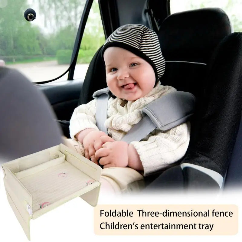 Child in car seat with a foldable entertainment tray.