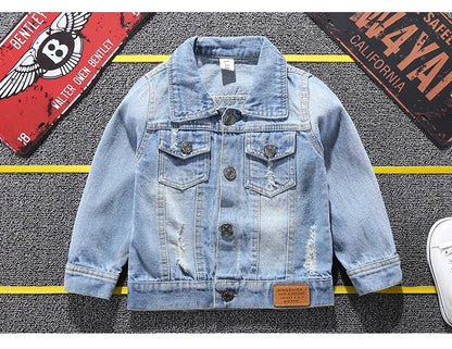 Mickey Mouse Designed Toddler Blue Denim Jacket Showcasing Front Design Laid in a Stripe Background With Car plates as props