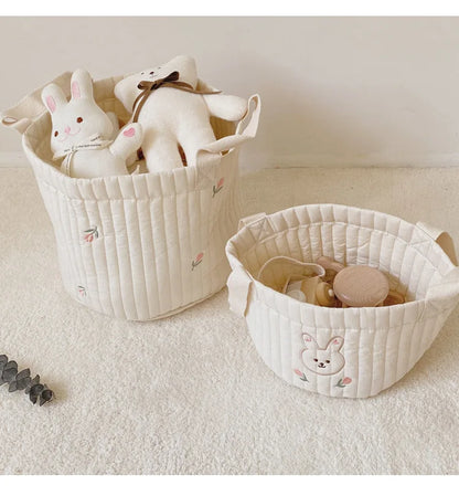 Two Baby Diaper Bag Caddy Organizer With Rabbit And Flower Design With Stuffed Toys Inside In A White Carpet Background