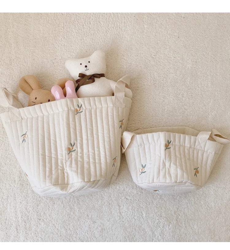 Small And Large Diaper Bag Caddy Organizer With Olive Design With Stuff toys Inside In A White Carpet And Background
