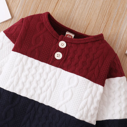 A Close Up Picture Of Red, White, and Navy Blue Colorblock Baby Jumpsuit Romper's Upper Portion