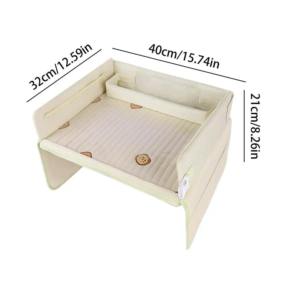 Beige fabric baby bed with dimensions marked, isolated on white background.