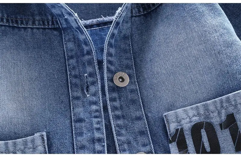A Close Up Picture Of Mickey Mouse Toddler Blue Denim Jacket's Buttons