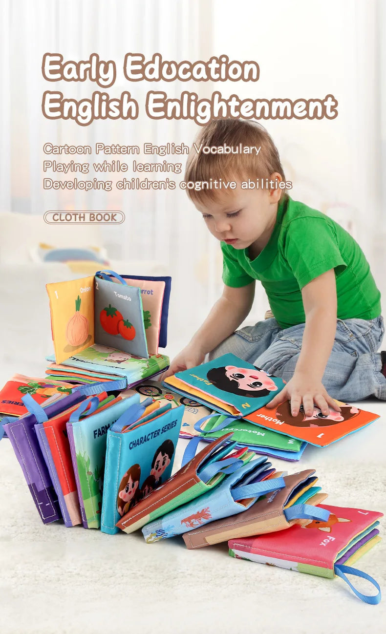 Child in green shirt sitting with assorted colorful cloth books spread around on floor.