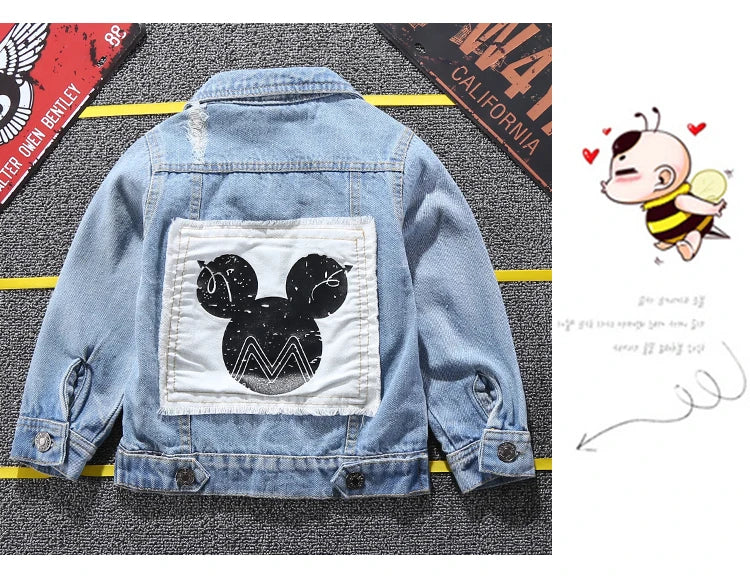 Mickey Mouse Designed Toddler Blue Denim Jacket Showcasing Back Design Laid in a Stripe Background With Car plates as props