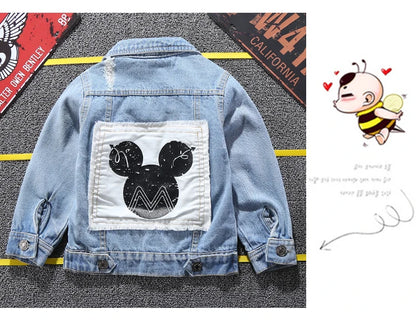 Mickey Mouse Designed Toddler Blue Denim Jacket Showcasing Back Design Laid in a Stripe Background With Car plates as props