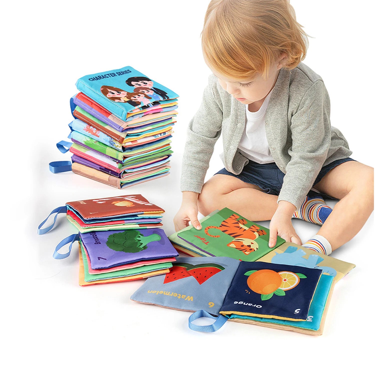 Child sitting and reading colorful books with a tall stack next to them.