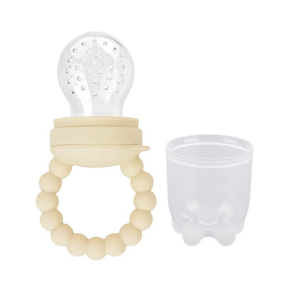 Baby teething toy with silicone bristle top and beaded handle next to its transparent cup.