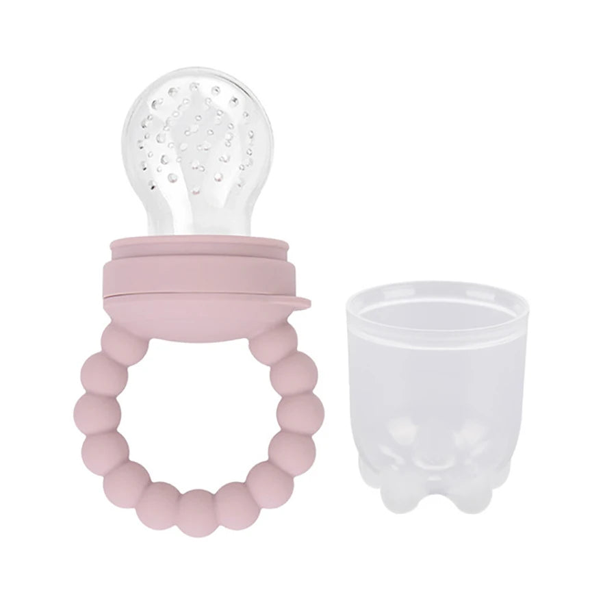Silicone baby teether with beads and a bulb-shaped top next to a transparent cup.