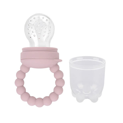 Silicone baby teether with beads and a bulb-shaped top next to a transparent cup.
