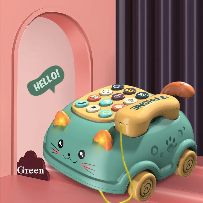 A cute green cat-shaped toy telephone with colorful buttons and a yellow handset.