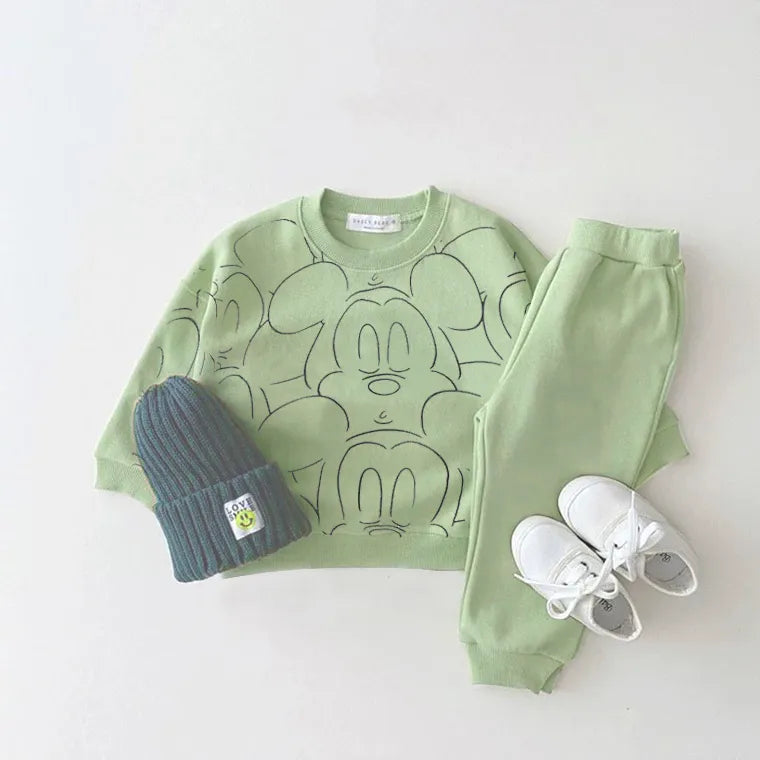 Green mickey mouse printed tracksuit set with long sleeve pullover shirt, green solid color pants, green beanie with white shoes in a gray background