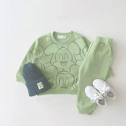  Green mickey mouse printed tracksuit set with long sleeve pullover shirt, green solid color pants, green beanie with white shoes in a gray background