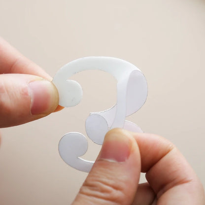 A person holding a number 3 sticker cutout