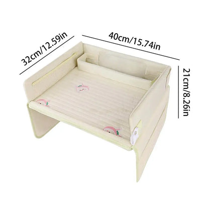 A beige portable baby bed with dimensions labeled, featuring cute animal designs.