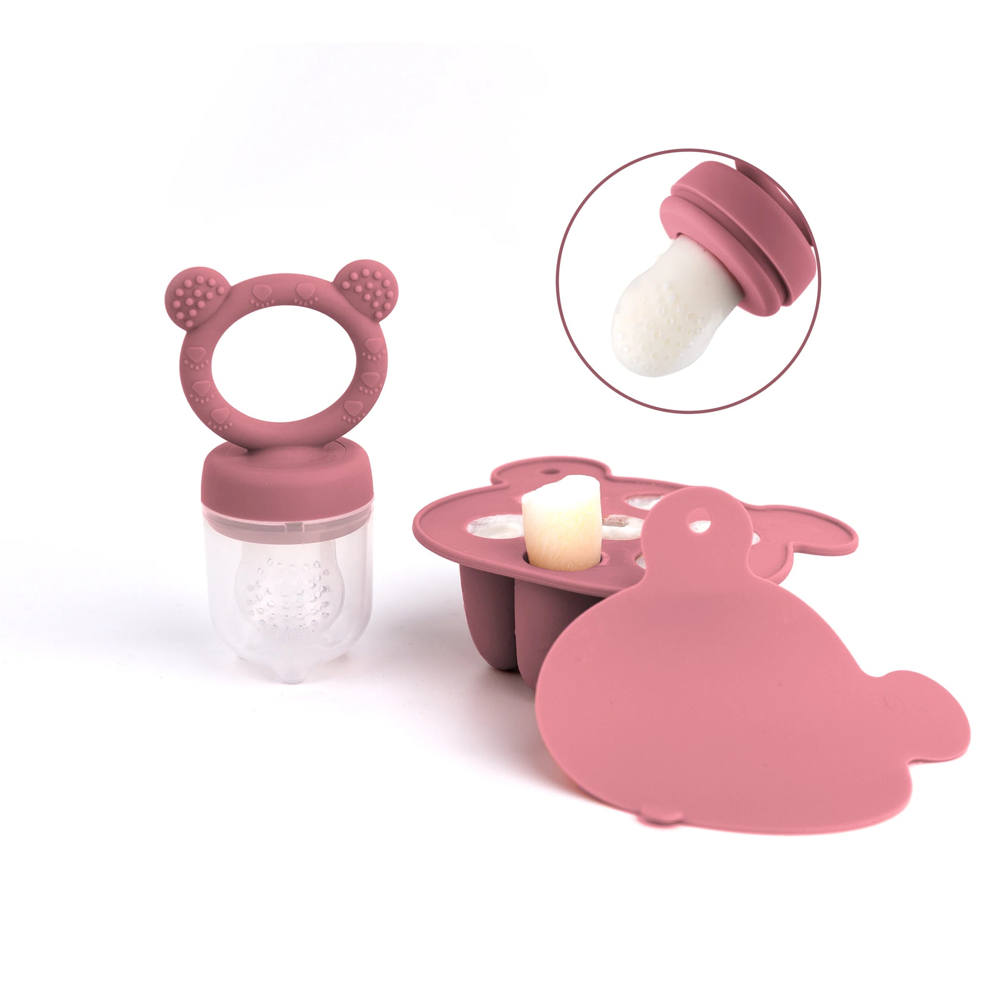 A pink baby fruit feeder with a silicone nipple and pacifier shaped like a bear.