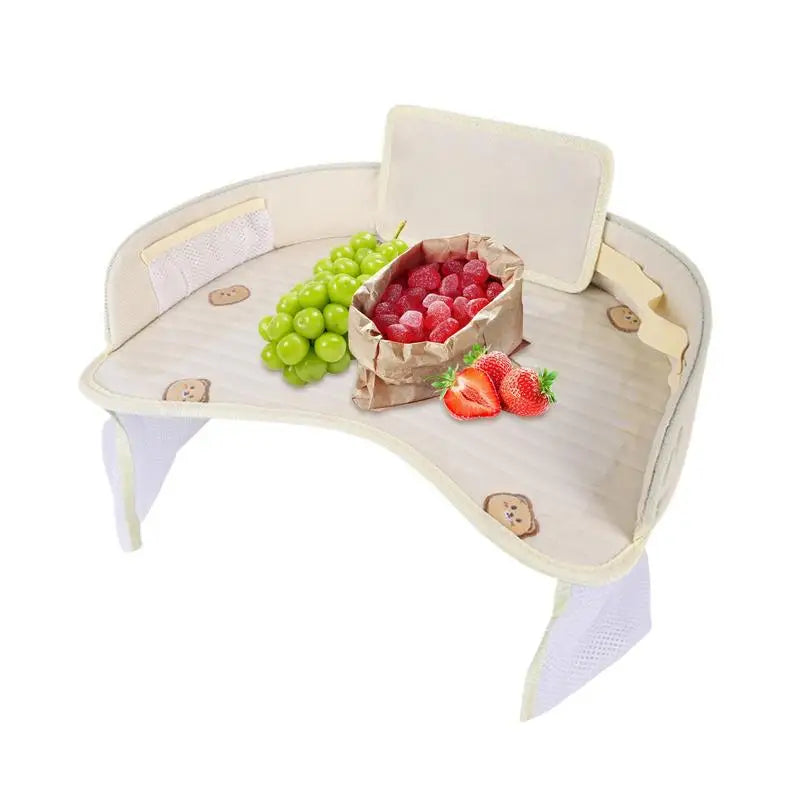Baby high chair tray with grapes, raspberries in a bag, and strawberries.