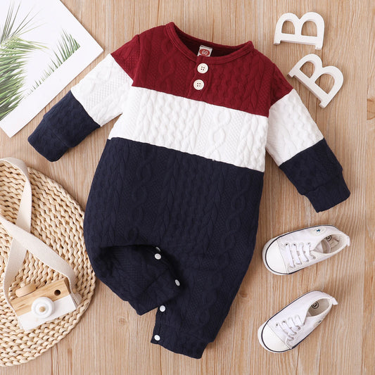 Red, White, and Navy Blue Colorblock, Cable Knit Baby Jumpsuit Romper Laid In A Light Wooden Background Alongside a White Shoes And Photoprops