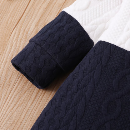 A Close Up Picture Of Red, White, and Navy Blue Colorblock Baby Jumpsuit Romper's Sleeve