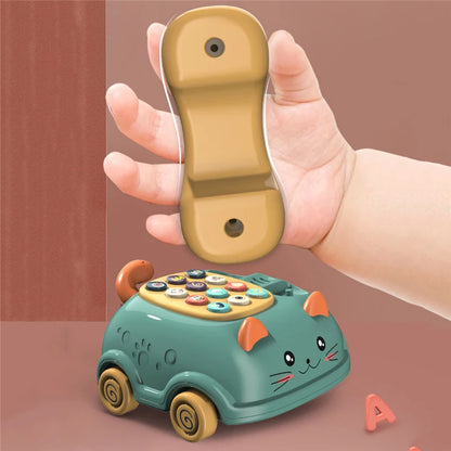 A hand holding a tan phone receiver above a teal toy cat-shaped phone with colorful buttons.
