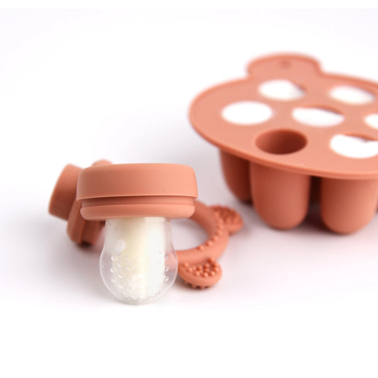 Silicone baby teething toy and milk bottle nipple on a white background.
