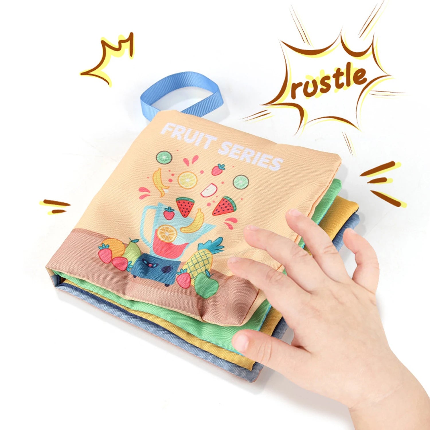 Child's hand flipping through a colorful fabric book with FRUIT SERIES and cartoon fruits on cover.