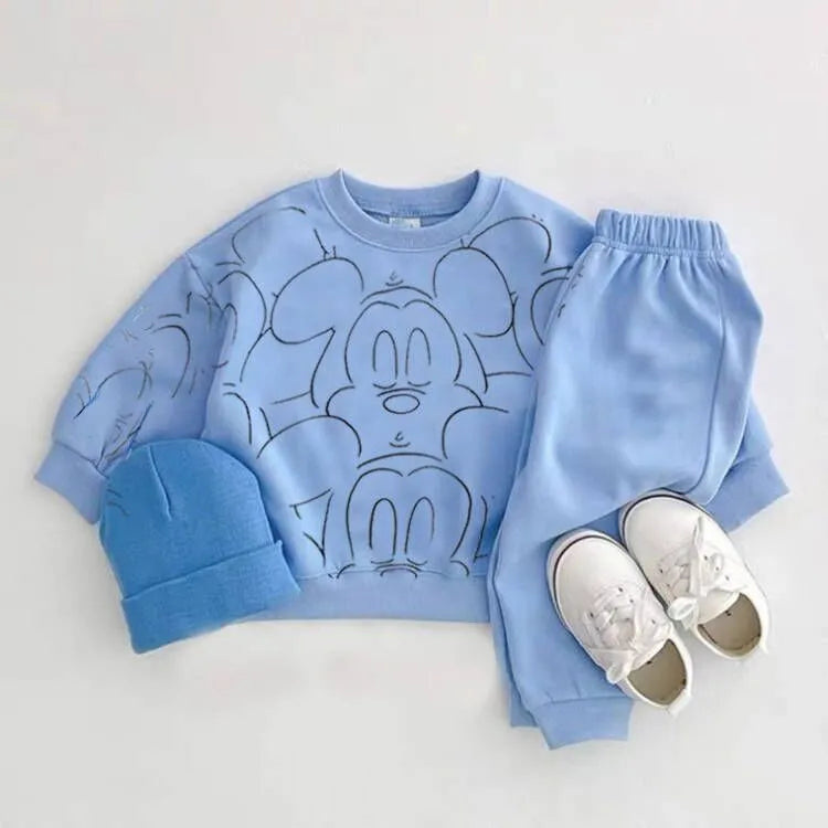 Blue mickey mouse printed tracksuit set with long sleeve pullover shirt, blue solid color pants, blue beanie with white shoes in a gray background